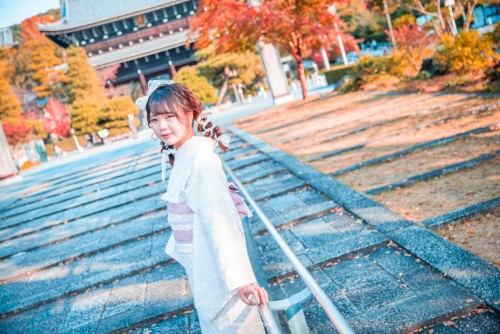 着物を着た女性のポートレート写真。紅葉がバックに咲いている。